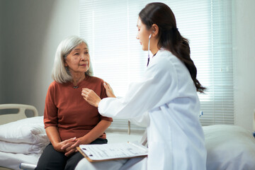 Fototapeta premium Doctor checking heart rate of senior patient during medical examination