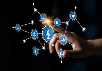 A hand reaches out toward a vibrant digital interface displaying various icons representing technology and business concepts, symbolizing innovation and growth. Tessel