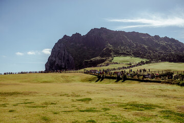 Seongsan Ilchulbong, Jeju Islands, South Korea, 10.10.2015: Majestic Hallasan Mountain on Jeju Island, surrounded by lush greenery, inviting hikers to explore its natural beauty