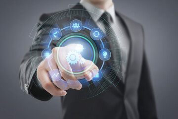 Businessman hand pointing at AI (Artificial Intelligence) on a futuristic digital interface with icons representing automation, data analysis, innovation, and network security.