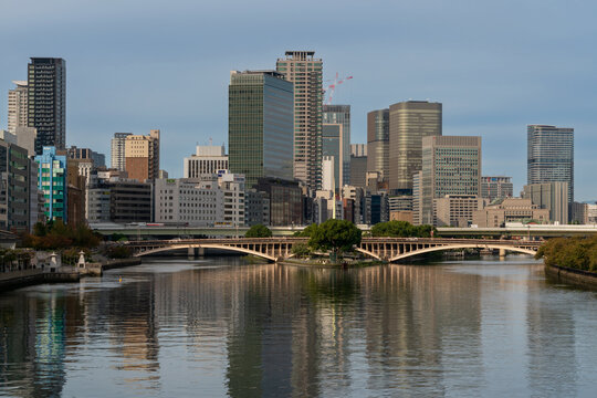 Urban landscape in the area of Temmabashi Station overlooking the Okawa River, Tenjin Bridge and Hachikenyahama Pier in Chuo-ku ward on a sunny autumn day, Osaka, Japan