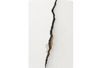 White wall with large vertical crack showing damage, destruction, repair need, and structural issue