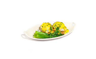 Eggs Benedict with Hollandaise Sauce, Poached Eggs, and Bok Choy on a White Plate