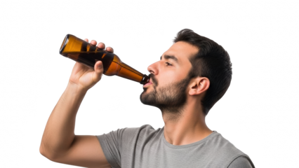 Man drinking beer from a bottle against a black background