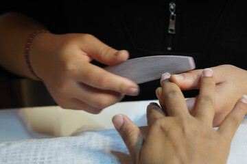 Obraz premium Nail care session at a beauty salon with careful attention