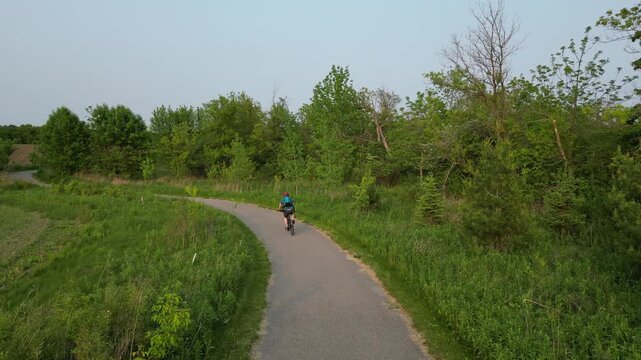 Aerial view of a mountain biker on a trail at sunset - Vue a&eacute;rienne d'un v&eacute;t&eacute;tiste sur un chemin au coucher de soleil
