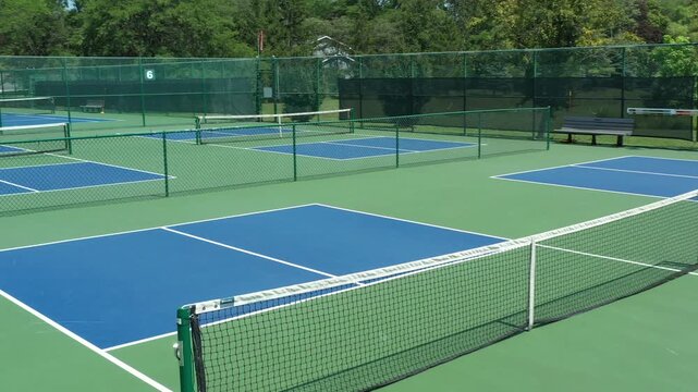 Aerial view of a pickleball facility in a suburban setting.