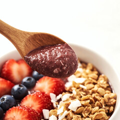 Vibrant Acai Bowl Action Shot Premium High-Resolution  of Healthy Superfood Breakfast with Spoon Scooping Fresh Toppings