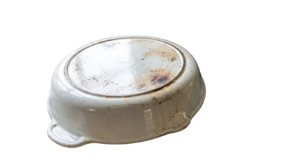 Underside of an old dirty white ceramic bowl with visible rust and wear marks reflecting neglect