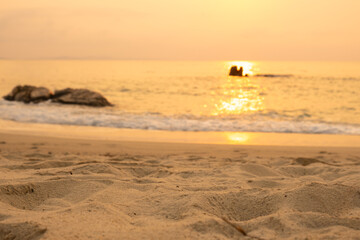 Nature sky breathtaking golden sunset over a calm ocean, with the entire sky and water bathed in brilliant shades of yellow and orange. Streaky clouds enhance the dramatic display of light