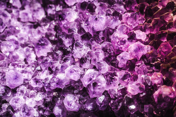 Dense amethyst crystal cluster with vivid purple tones and sharp geometric formations