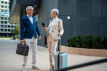 Senior business partners conversing during corporate travel