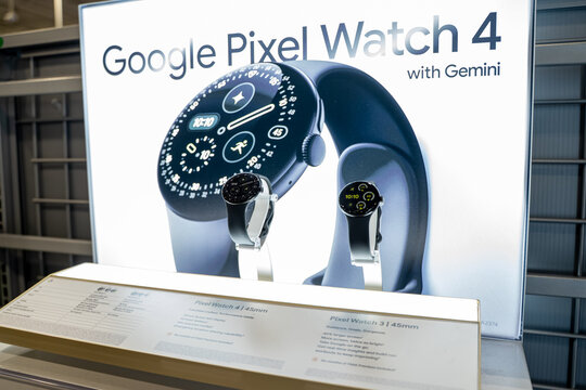 View of Google Pixel Watch 4 display with smartwatch models in a retail store. Milton, Canada - November 29, 2025.