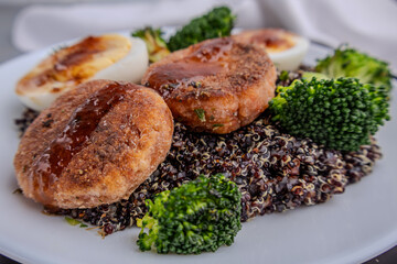 Nutritious Quinoa Bowl with Broccoli, Boiled Eggs, and Savory Patties