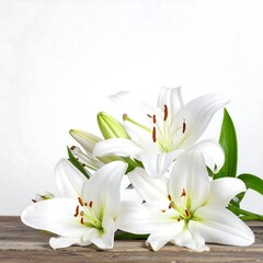Obraz premium A cluster of white lilies rests on a rustic wooden surface against a stark white backdrop. Vibrant green leaves add contrast