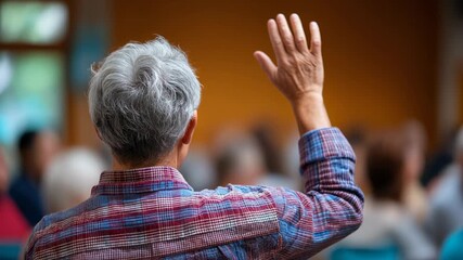Engaged Senior Raising Hand in Community Meeting for Participation and Discussion