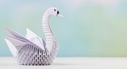 A white origami swan on a blue and green background.