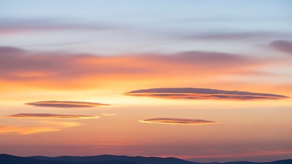 Fototapeta premium Lenticular Clouds at Sunset over Mountain Range, Orange and Purple Sky