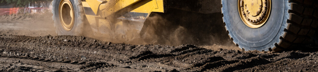 Wheel Tractor Scraper moving mineral dirt and working on groundwork for new housing development...