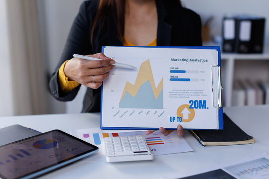 Closeup hand of Chief discuss monthly earning graph Analyzing data dashboard, business analytics, financial chart, together in the office