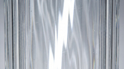 Abstract textured glass background with prismatic light refraction and caustics.
