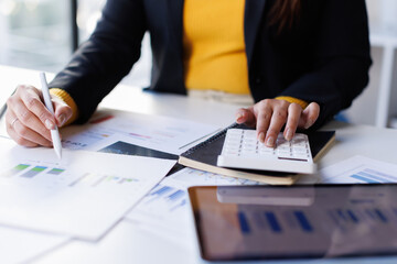 Business woman in formal suit working with monthly report balance sheet and yearly tax of accounting to verify the account by an authorized auditor