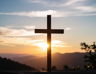 Silhouette of the Christian cross, a symbol of faith and hope, against the beautiful sunset sky with clouds and bright spiritual light