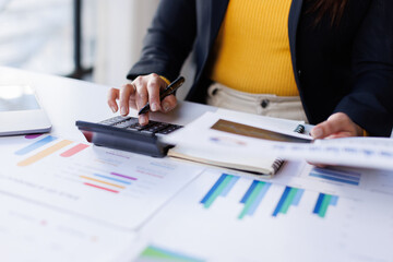 Business woman account financier audit using calculator and analyzing data annual report calculator Accounting tax.
