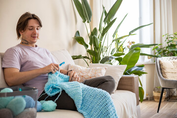 Hipster feminine male crochet handmade knitting hobby with colored yarn and hook at white interior