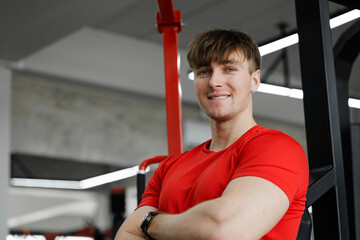 Confident fitness trainer inviting you to join the gym