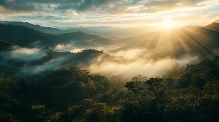 Majestic sunrise over a misty mountain range with the sun's rays breaking through the clouds.