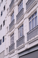 Fototapeta premium Elegant Hotel Facade with Classic Iron Balcony Railings