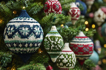 Festive knitted Christmas ornaments hanging on a lush tree, bringing cozy holiday charm and a touch of vintage elegance to seasonal decor