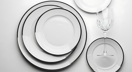 Elegant white plates and glass arrangement on white background