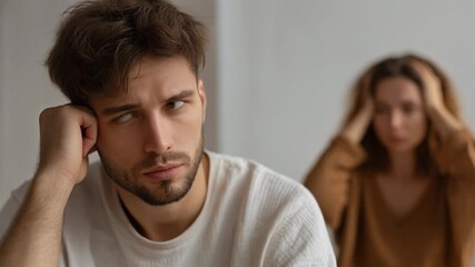 Emotional couple in conflict, showcasing relationship stress and tension in a modern home setting