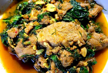 Fried chopped pork with  shrubby basil in pan, indoor Chiangmai Thailand.