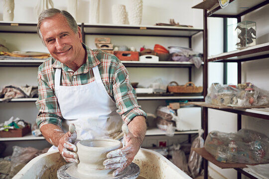 Clay wheel, portrait and old man in workshop with pottery, happiness or creative hobby in retirement. Art, ceramic and person in studio with creation, practice or sculpture craft in senior activity. - Powered by Adobe