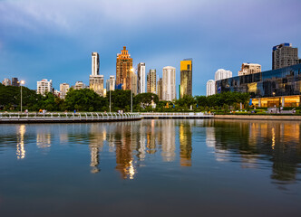 View of Ratchada Lake at cloudy afternoon in Benchakitti Park. Bangkok cityscape at Benjakitti Park.