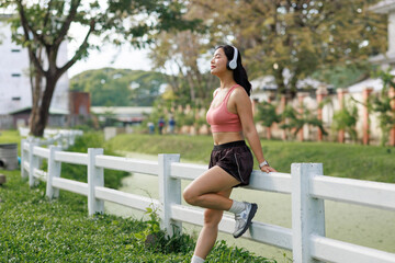 Young woman relaxing enjoying music in nature
