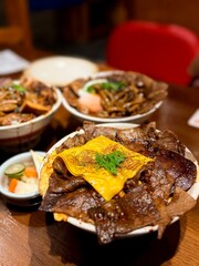 Grilled beef and red cheese in bowls