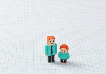 Colorful Toy Figures of Parent and Child on Graph Paper Background with Playful Atmosphere