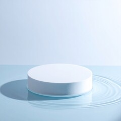A pristine white circular podium floats on a light blue rippled surface, against a pale blue background.  Soft shadows accentuate the form
