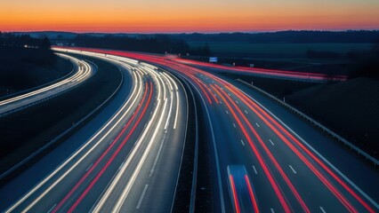 Long exposure shot of a highway with car light trails during a dusk or dawn sky