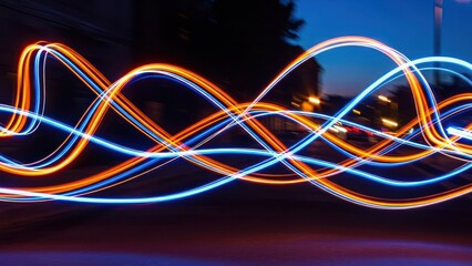 Long exposure shot of colorful light trails winding across a dark street at night