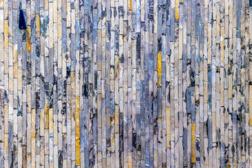 Colorful stone wall with vertical patterns and textures