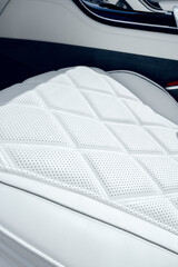 Fototapeta premium Modern car interior with detailed white leather seat design and perforations on display