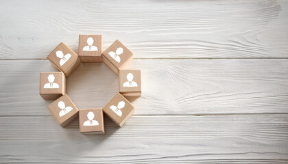 Wooden Blocks with Human Icons Arranged in Circular Shape on White Rustic Wooden Tabletop