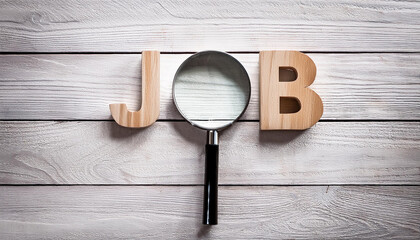 Magnifying Glass Searching for Job Concept on Wooden Surface with Wooden Letters J and B
