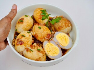 Son in Law Eggs is in a cup placed on a white background. It looks delicious. Thai food that I made myself and it is delicious.