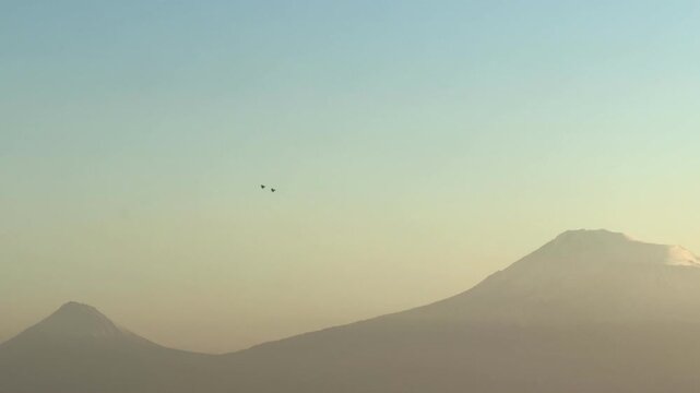 NATO fighter jet over a city near Mount Ararat and Yerevan, Two fighter jets in the sky perform a dangerous maneuver, pilots are preparing, dangerous turns. War. Middle East. 10.03.2025. High quality 